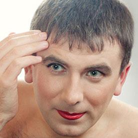 Illustrative photo of a crossdresser applying makeup. Not an actual member.